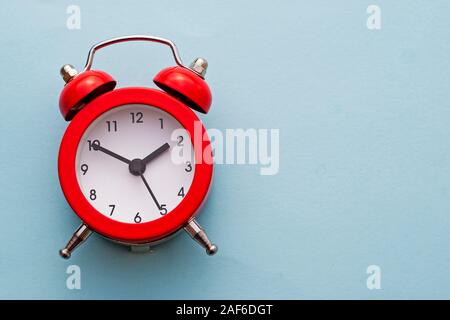 Colorful red traditional alarm clock with bells Stock Photo