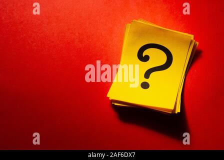 Stack of bright yellow cards with question marks Stock Photo