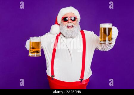 Portrait of nice drunk cheerful cheery glad bearded thick fat Santa having fun offering drinking beer night club bar isolated over bright vivid shine Stock Photo