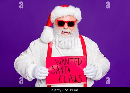 Close-up portrait of his he nice angry aggressive evil mad fury bearded Santa demonstrating placard wanted search needed isolated over bright vivid Stock Photo