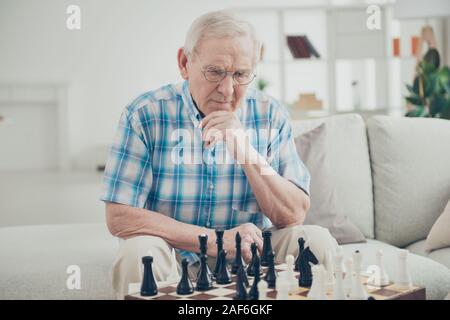 Portrait of his he nice focused concentrated intelligent experienced man playing chess creating move pieces win winner amateur championship in light Stock Photo