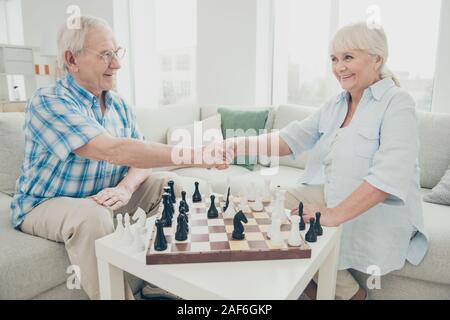 Profile side view portrait of his he her she two nice attractive cheerful cheery friendly intelligent people shaking hands win winner amateur Stock Photo