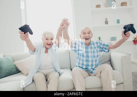 Portrait of her she his he two nice attractive cheerful cheery glad excited ecstatic positive spouses having fun enjoying battle contest win winner in Stock Photo