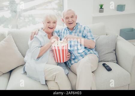 Above high angle view of two nice attractive cheerful cheery positive spouses having fun spending free time watching serial funny cinema in light Stock Photo