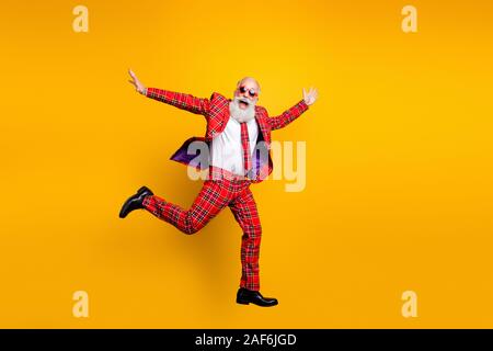 Full body photo of funny hipster grandpa white beard guy jumping high exciting trip wear plaid red blazer tie trousers outfit isolated yellow bright Stock Photo