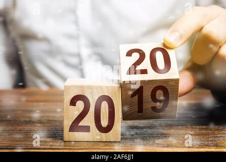 Two wooden blocks with numbers 2019 and 2020. Concept beginning of new year. New objectives. in next decade. Trends in the world. Build plans and goal Stock Photo