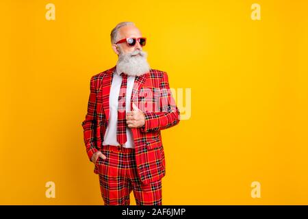 Photo of cool grandpa white beard model guy standing self-confidently posing for magazine cover wear sun specs tartan red costume outfit isolated Stock Photo