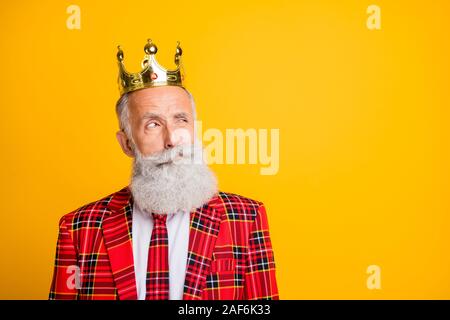 Close up photo of cool look grandpa white beard vip person looking distrustful empty space wear crown tartan red blazer tie clothes isolated yellow Stock Photo