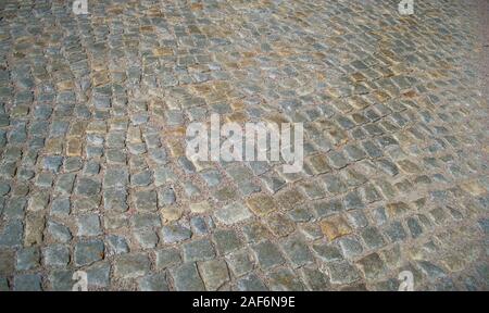 Texture of an old paving stone road from European countryside Stock Photo