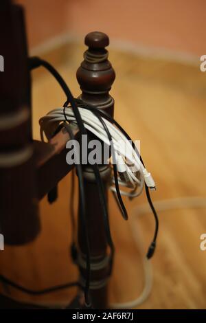 Smartphone cable or broken phone cable hangs on desks Stock Photo