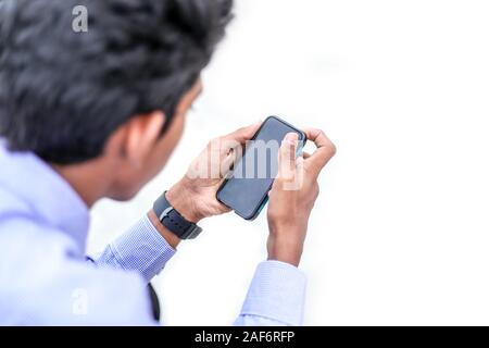 Man uses his Mobile Phone outdoor Stock Photo