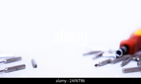 Screwdrivers and screws isolated on white background Stock Photo