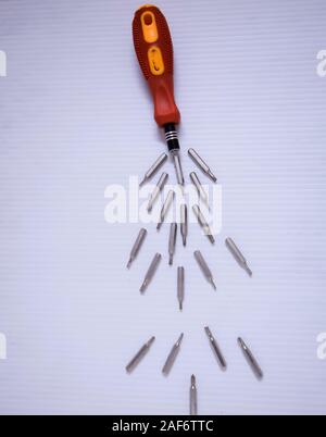 Hand screwdrivers and screws on white background Stock Photo