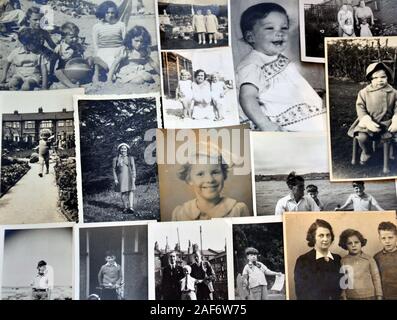 A collection of old, vintage black and white family photographic prints or photos. Retro theme. Stock Photo