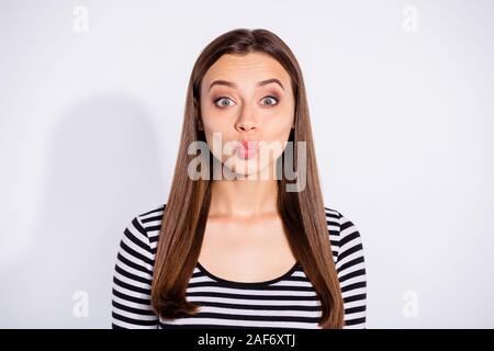 Portrait of lovely person with her lips pouted plump wearing striped sweater isolated over white background Stock Photo