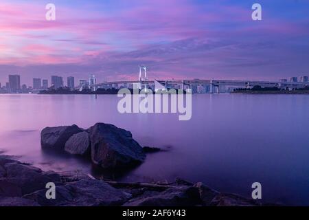 Longtime exposure at the Rainbow Bridge in Tokyo during sunset Stock Photo