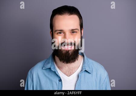 Closeup photo of toothy smiling macho guy perfect appearance neat long hairdo bristle young promoted chief wear casual denim outfit isolated grey Stock Photo