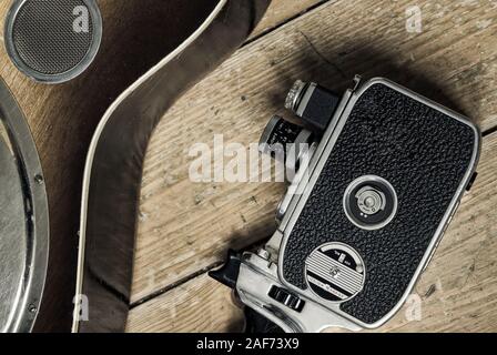 A vintage film camera and a detail of a Dobro guitar on a wooden background Stock Photo