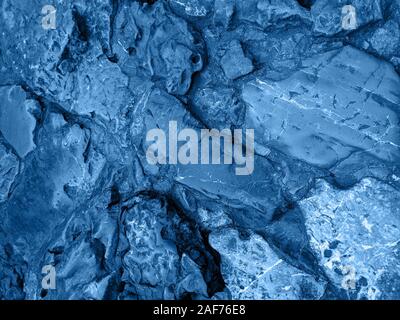 The background or texture of the rock. The surface of the stone. Blue colour toned. Stock Photo