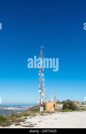 Telecoms masts and buildings on the mountain top Puig de la Llorenca above Cumbre Del Sol, Spain. Stock Photo