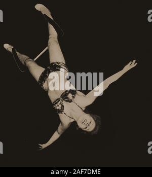 A Vintage photograph taken at Miller's circus  (UK)  Anita the trapeze artist during a performance Stock Photo