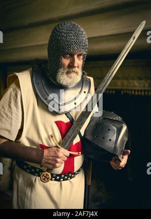 Authentic knight in medieval crusader outfit with helmet, chainmail and ...