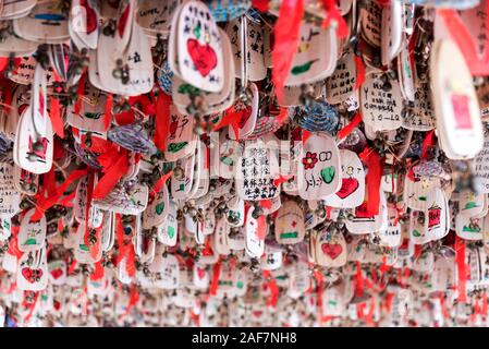 March, 15. 2019: Prayers and wishes on wooden plates hanged. Lijiang, China Stock Photo