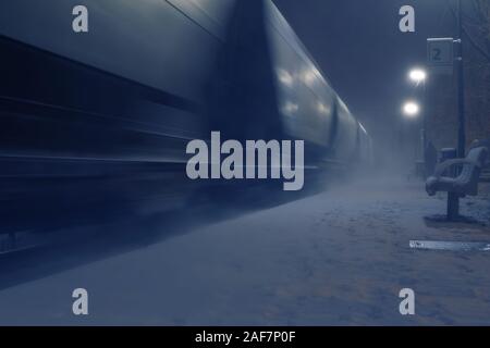 Passing cargo train in blurred motion at train station on a winter night. Transportation and logistic service concepts Stock Photo