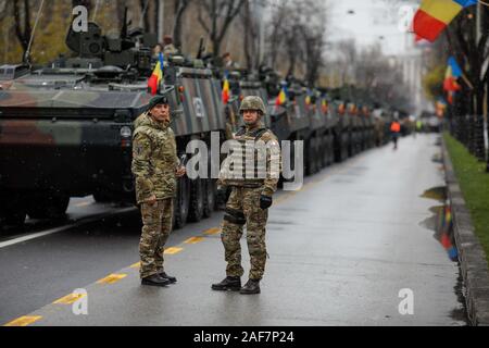 Bucharest, Romania - December 01, 2019: Romanian army soldiers near armored vehicles at the Romanian National Day military parade. Stock Photo