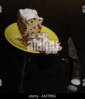 Slices of cake with raisins on dark table. Stock Photo