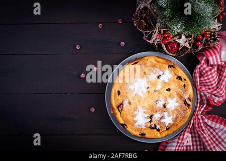 Christmas fruit cake, pudding on dark table. Top view, overhead, copy space. Stock Photo