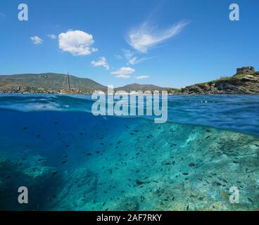 Spain, Mediterranean seascape near Cadaques, coastline with many fish in the sea, Costa Brava, split view over and under water surface, Catalonia Stock Photo