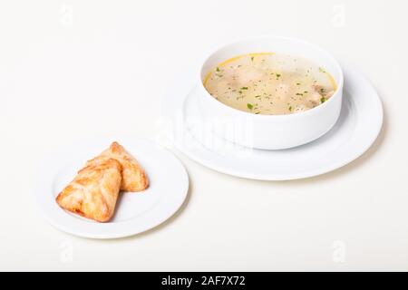 Russian clear fish soup with open-topped pastry called rasstegai Stock Photo