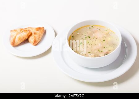 Russian clear fish soup with open-topped pastry called rasstegai Stock Photo