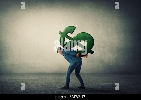 Businessman carrying a big american dollar sign on his back. Overloaded guy, difficult burden and debt pressure. Business corruption issue. Financial Stock Photo