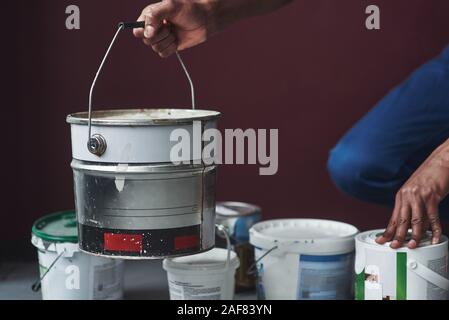 Close up view. Young african american worker in the blue uniform have some job Stock Photo