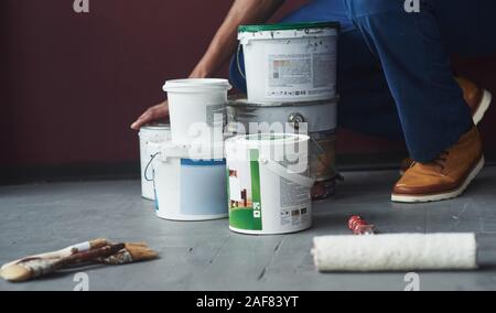 Items on the floor. Young african american worker in the blue uniform have some job Stock Photo