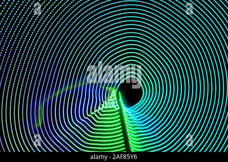 Abstract curved background with moving neon colored lines on black ...