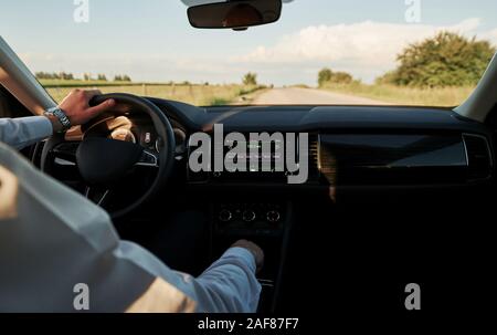 Switching gear. Driver feels good in his brand new car. Riding at sunny day Stock Photo