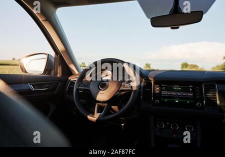 Reflection in the mirror. Inside modern car. Front panel, steering wheel, quality material Stock Photo