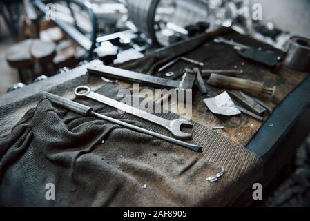 Place of work. Tools on dirty table. In garage. Manufactory conception Stock Photo