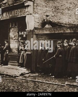 Seige of Sidney Street -The Siege of Sidney Street (January 1911), also known as the Battle of Stepney, took part in the  East End of London between British police supported by soldiers, Following a robbery and the killing of three police officers by Latvian revolutionaries.  This historic photograph shows a young Winston Churchill (the then Home Secretary) standing shoulder to shoulder with police and soldiers. Stock Photo