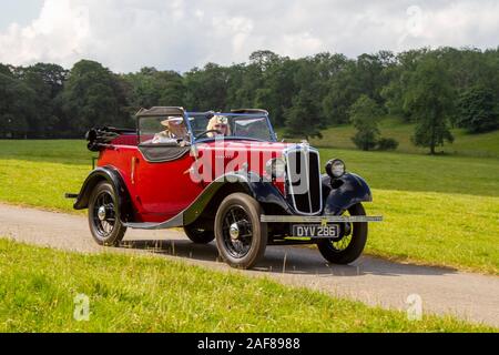 1937 30s pre-war red Morris: Classic cars, historics, cherished, old timers, collectable restored vintage veteran, heritage vehicles of yesteryear arriving for the Mark Woodward historical motoring event at Leighton Hall, Carnforth, UK Stock Photo