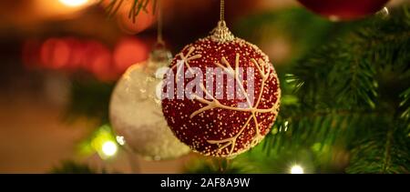 Christmas tree ornament decoration. Xmas balls hanging on a fir branch, closeup view, banner Stock Photo