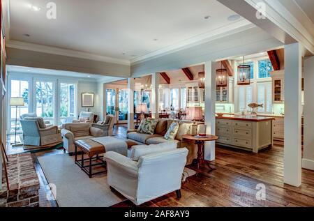 Large open concept home interior with living room, kitchen, and dining room. Stock Photo