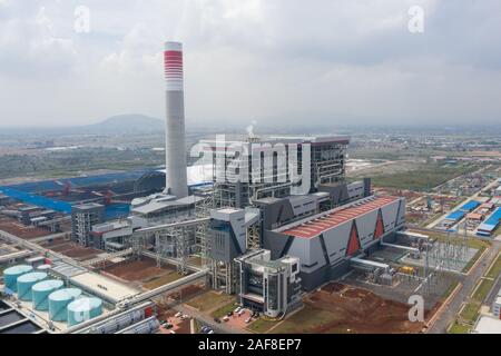 Banten, Indonesia. 13th Dec, 2019. Aerial photo taken on Dec. 13, 2019 shows the power plant PLTU Java 7 in Bojonegara subdistrict of Banten province, Indonesia. Unit 1 of Indonesia's coal-fired power plant PLTU Java 7 developed by a consortium of Chinese and Indonesian companies officially kicked off commercial operation on Friday. The PLTU Java 7 power plant is currently operated by PT Shenhua Guohua Pembangkitan Jawa Bali which is a joint venture between China Shenhua Energy Co. Ltd. and PT Pembangkitan Jawa Bali - a subsidiary of Indonesia's state-owned electricity firm Perus Credit: Xinhu Stock Photo