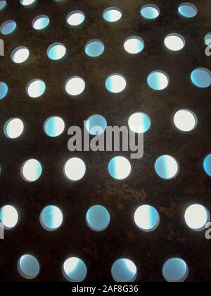 Perforated sheet, perforated iron plate for industrial background. Stock Photo