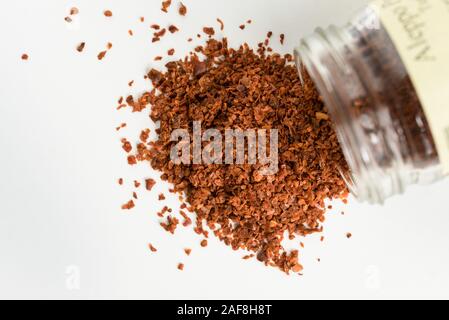 Aleppo Peppers Spilled from a Spice Jar Stock Photo