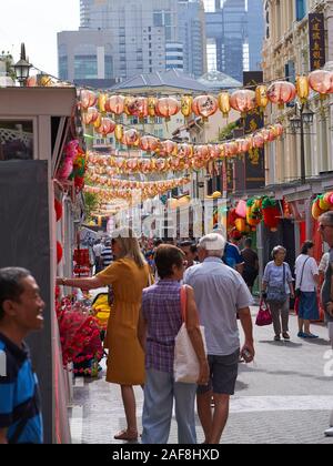 People walking down Pagoda street and checking market stalls in Chinatown Stock Photo