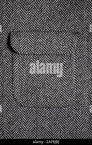 The texture of the fabric for the coat. Closeup of wool herringbone fabric. weed, Wool Background Texture. Stock Photo